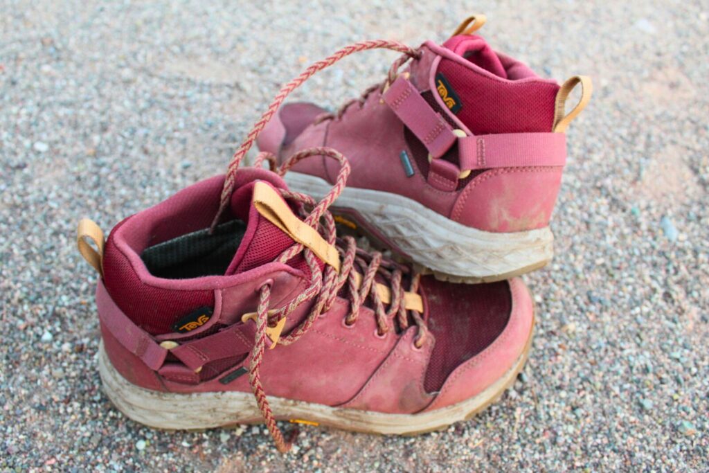 Pair of the Teva Grandview GTX Mid women’s hiking boots on a dirt background