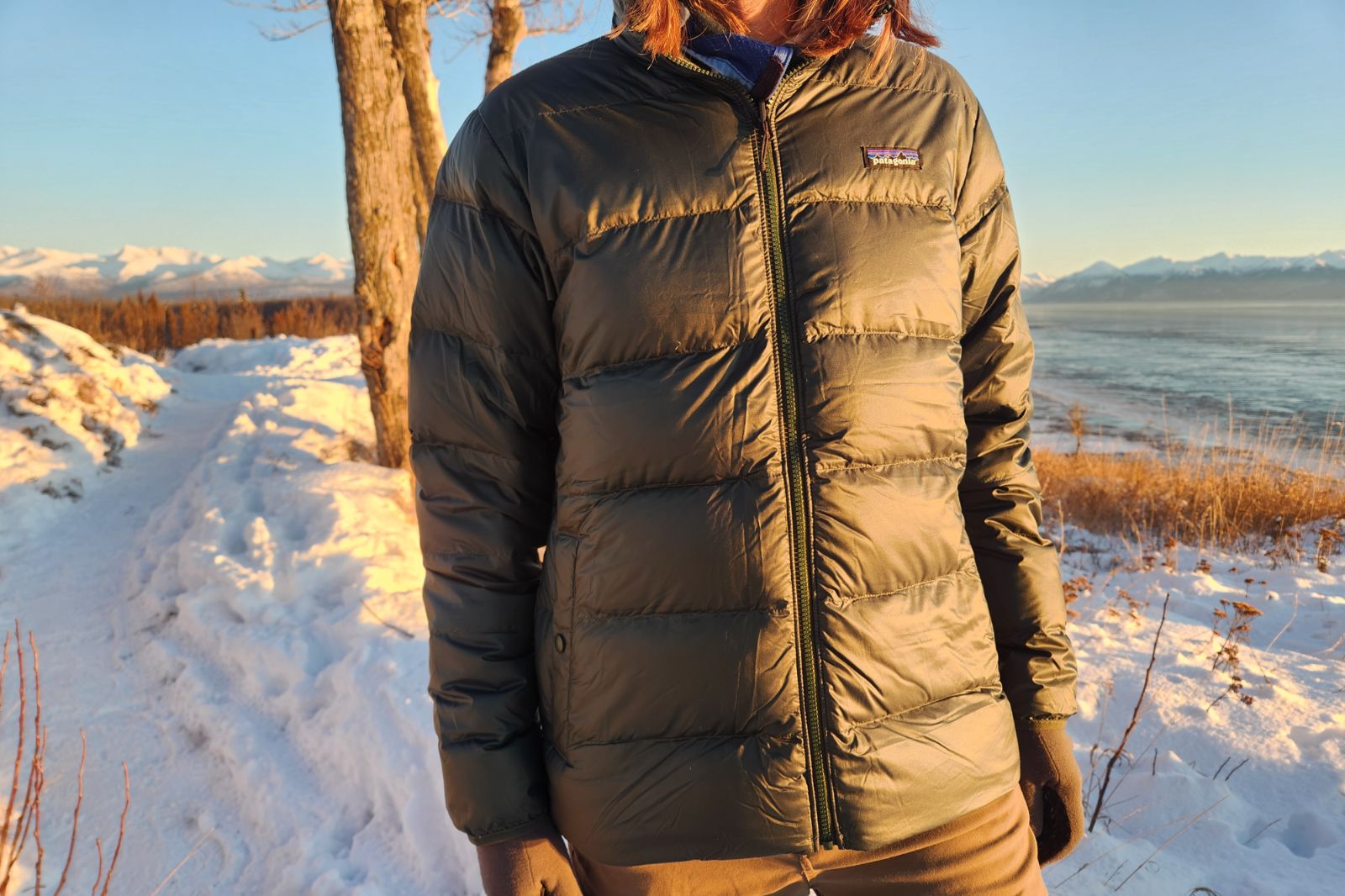 A closeup of a green down jacket.