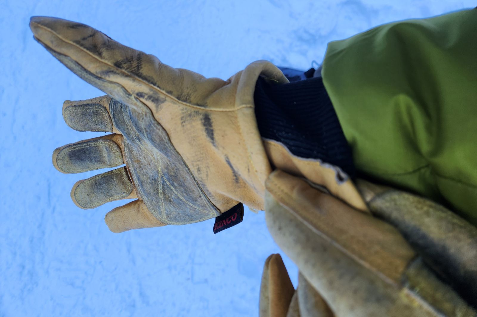 A cloeup of the pull tab on leather gloves.