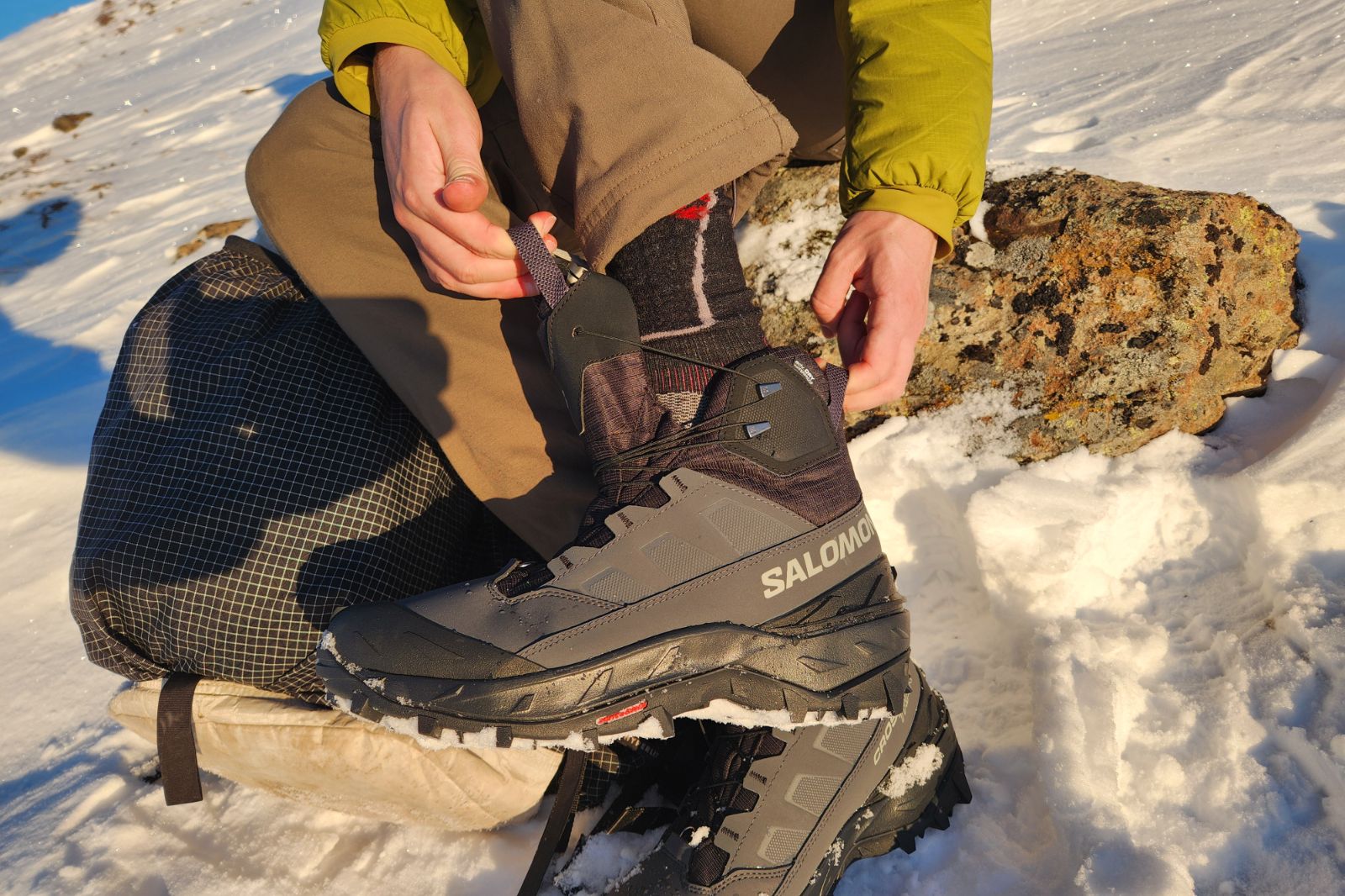 A man puts on his winter boots.