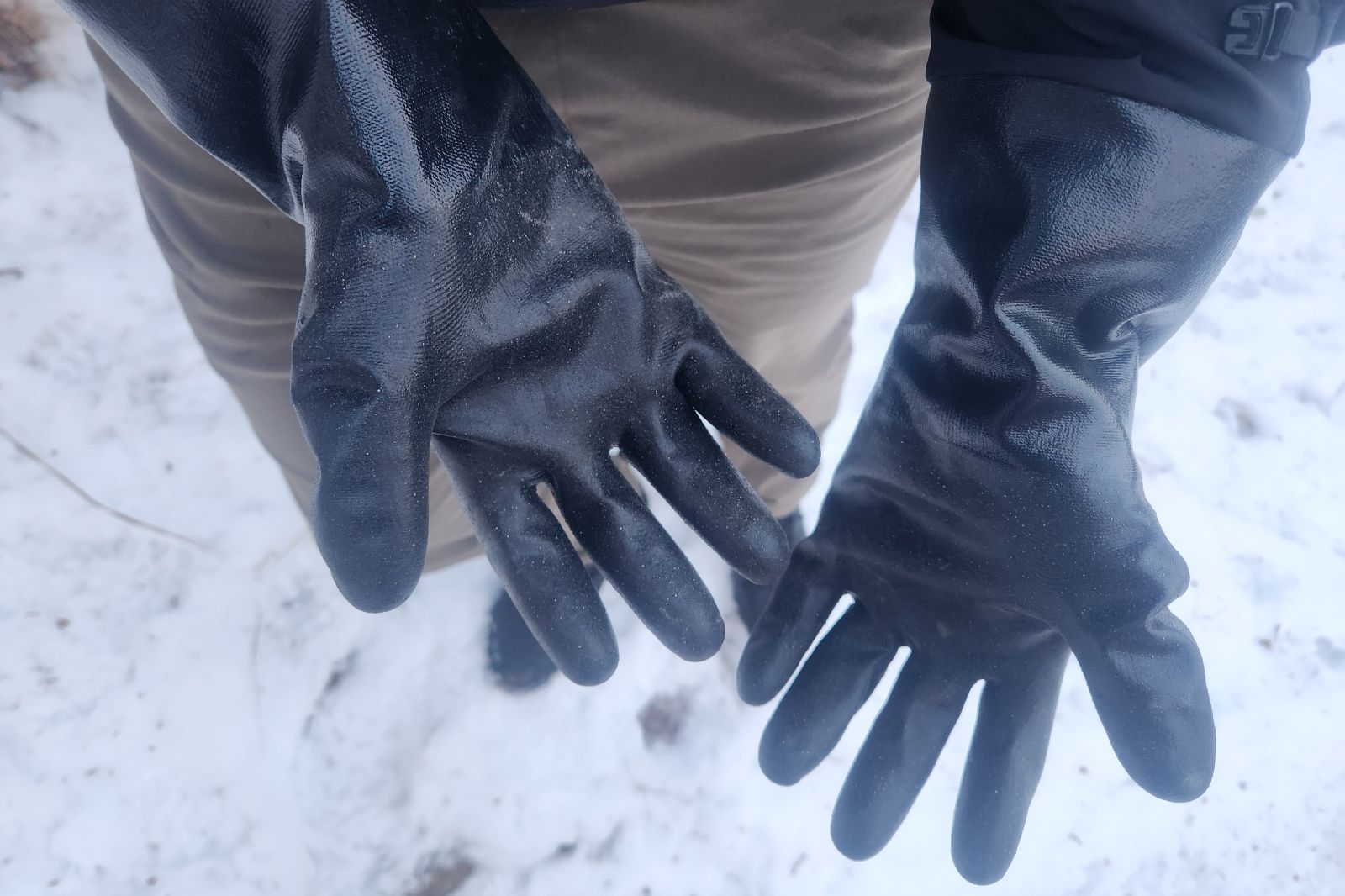 A close-up of the palms of black gloves.