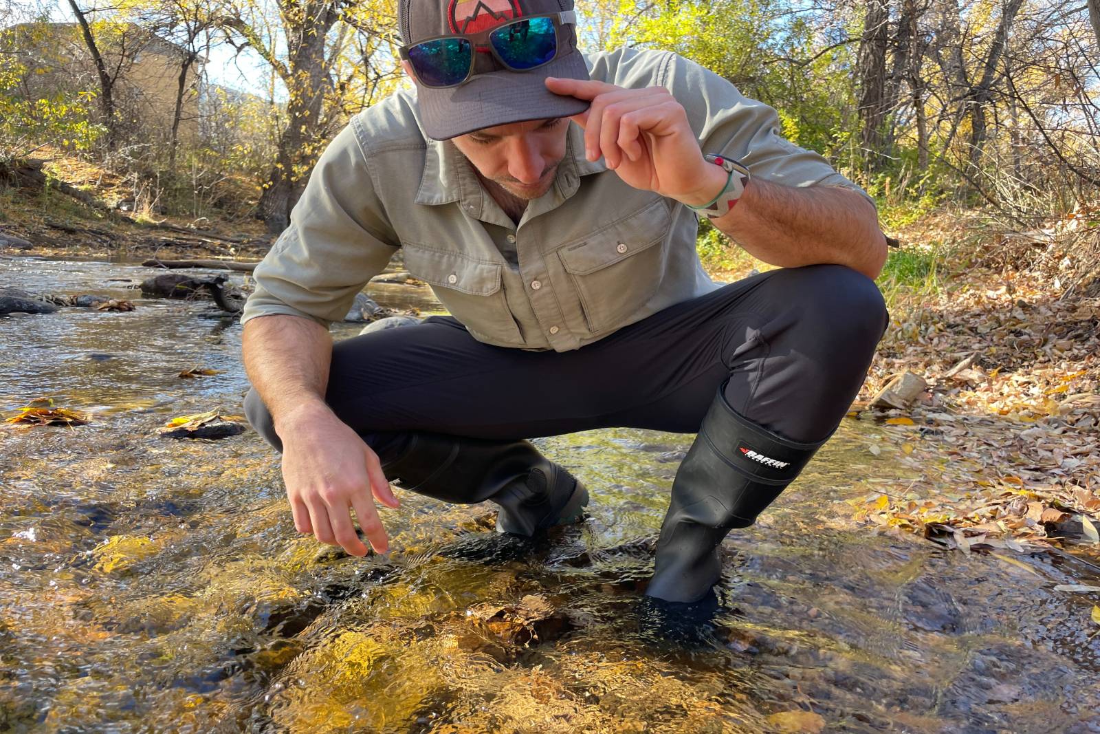 Squatting in a stream looking for aquatic life in the Baffin Enduro's.