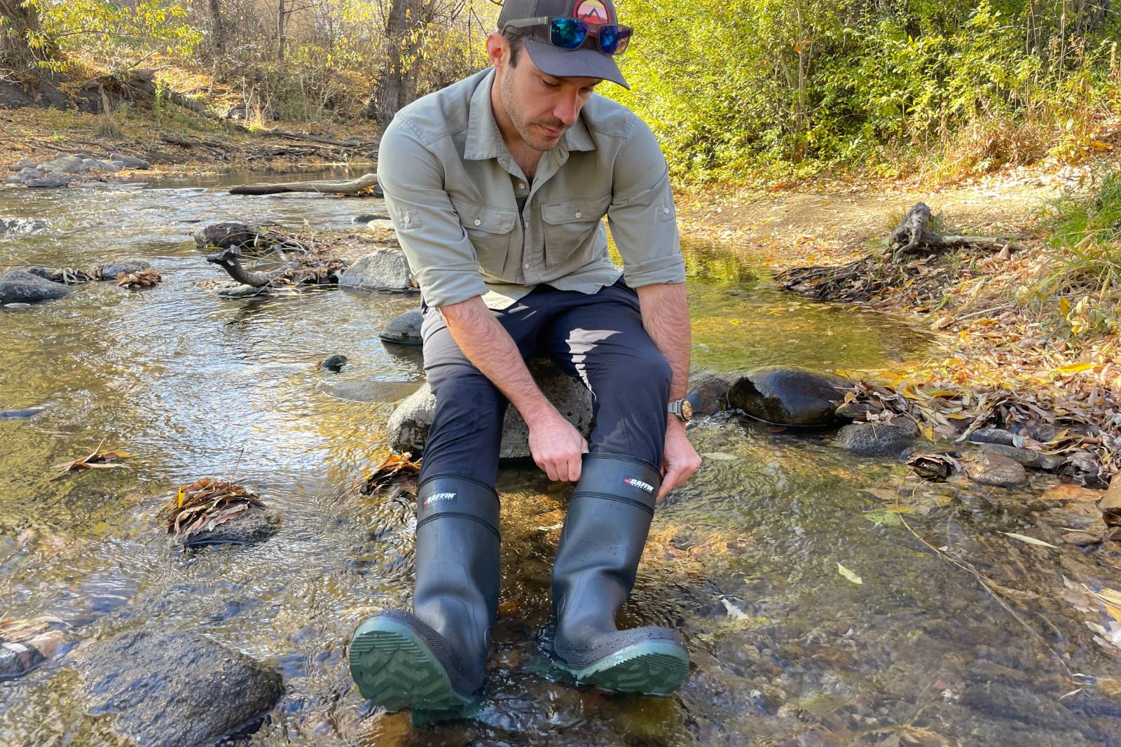 Adjusting the fit of the Baffin Enduro's while sitting on a rock in a stream.