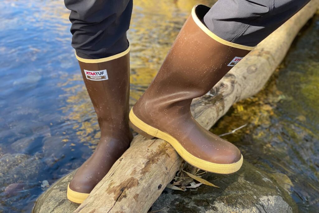 Standing on a log in the XTRATUF 15" Legacy Boots