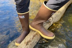 Standing on a log in the XTRATUF 15" Legacy Boots