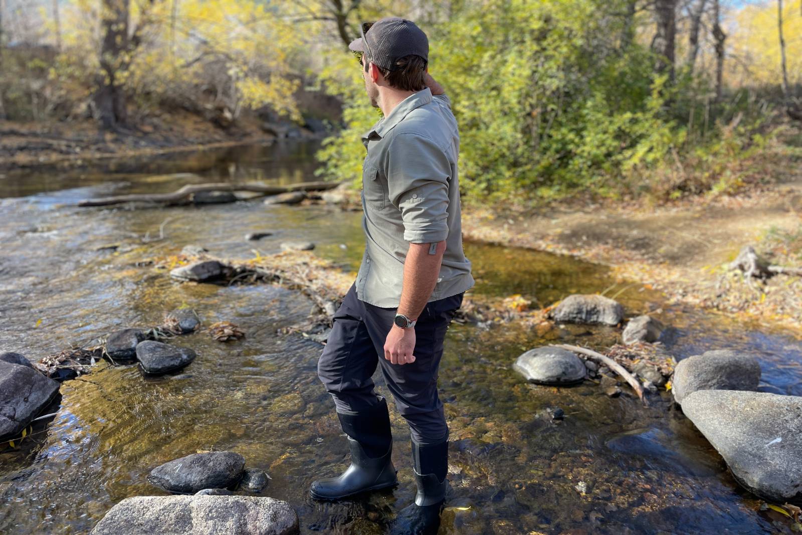 Looking off in the distance searching for ducks while standing in a stream in the Bogs Classic Seamless Tall Boots.