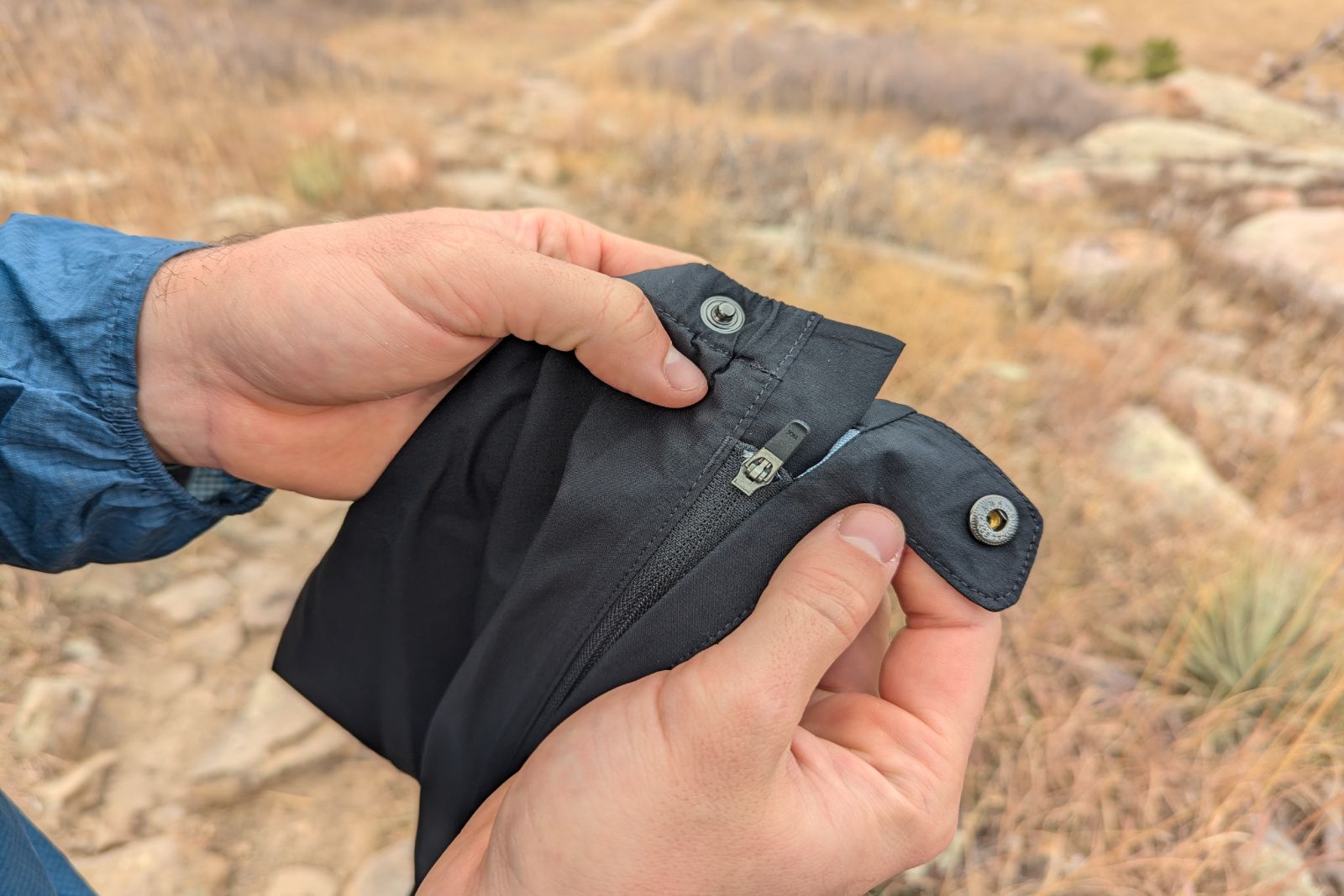 Showing the ankle closure and snap buckle on the Mountain Hardware Stretch Ozonic pants.