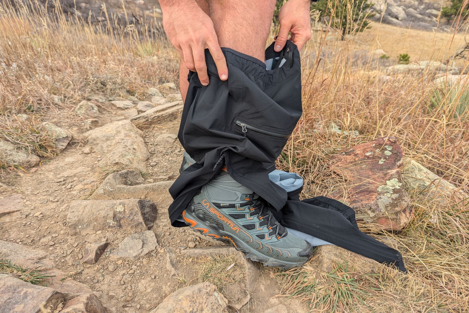 Putting the Mountain Hardware Stretch Ozonic pants on over a pair of waterproof boots.