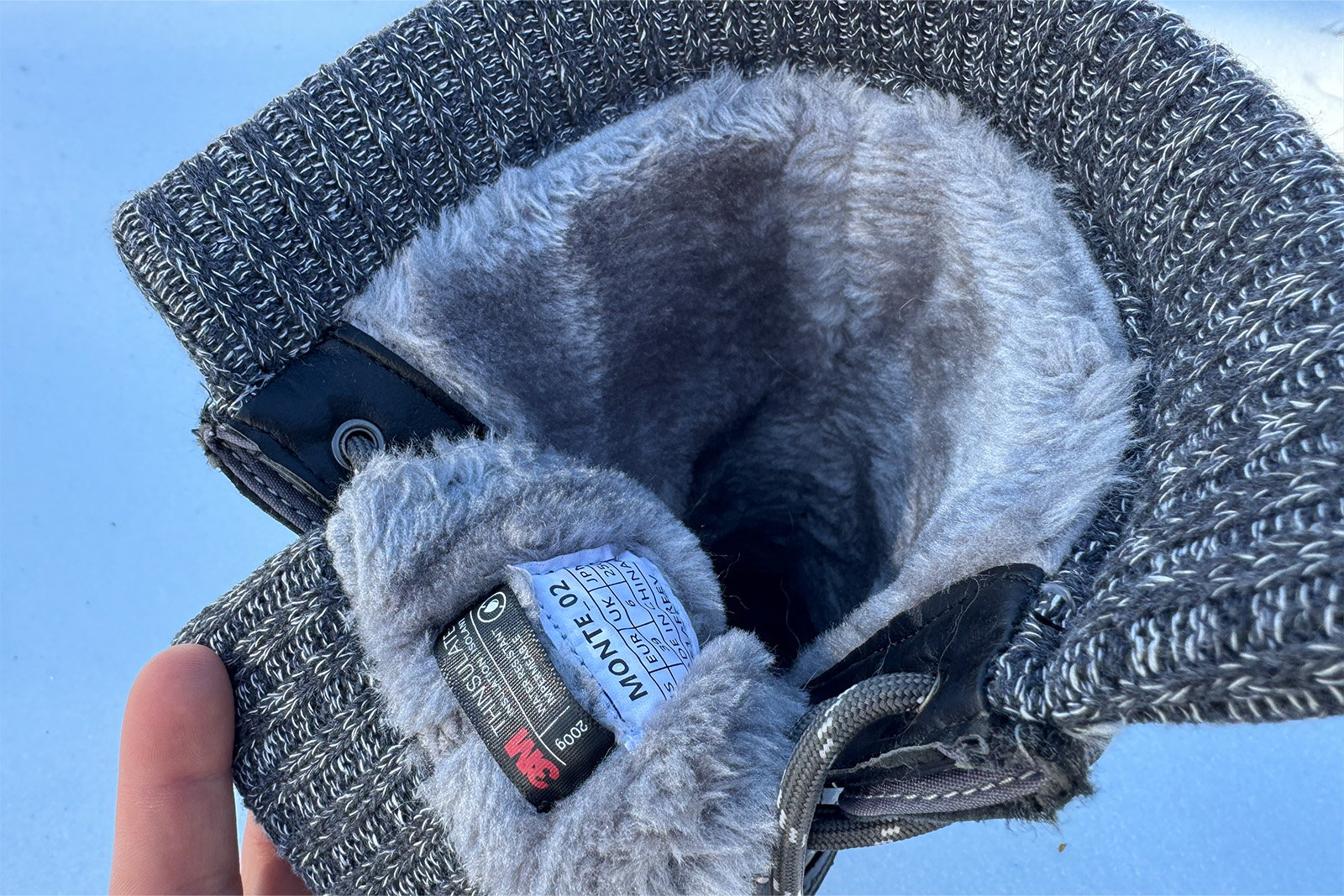 A close up of the inner lining of the Dream Pairs boots shows faux fur and a knit collar at the top.