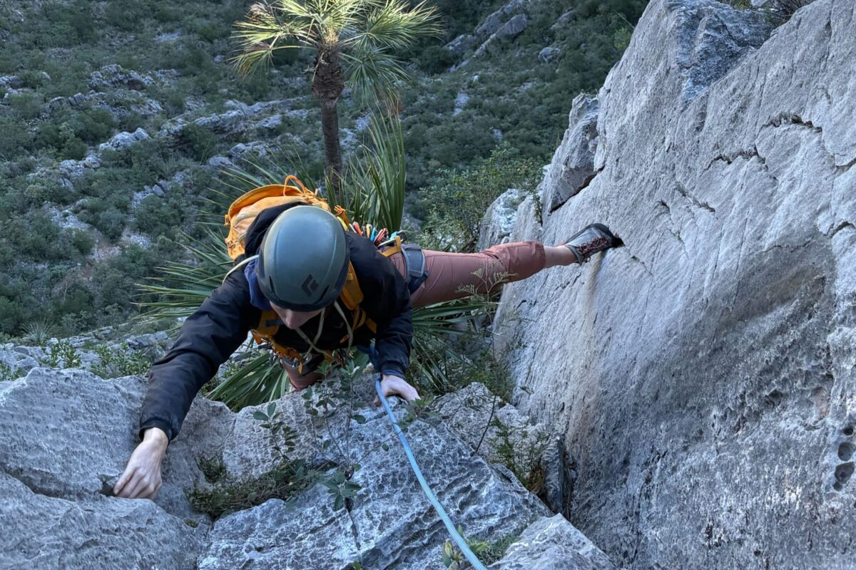 woman rock climbing wearing an arc'teryx atom hoody