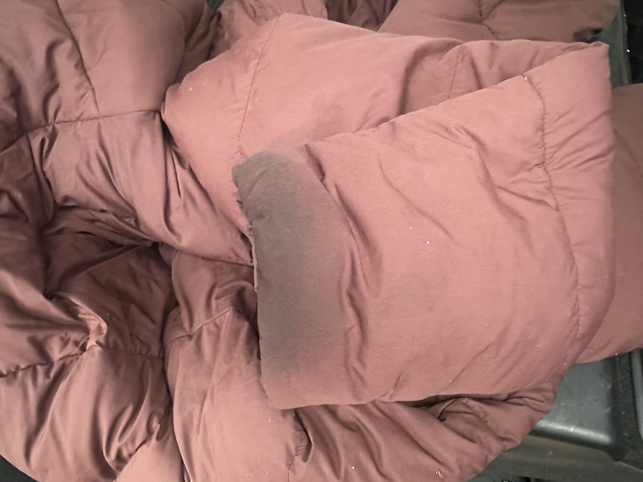 the cuff of a down parka discolored from use