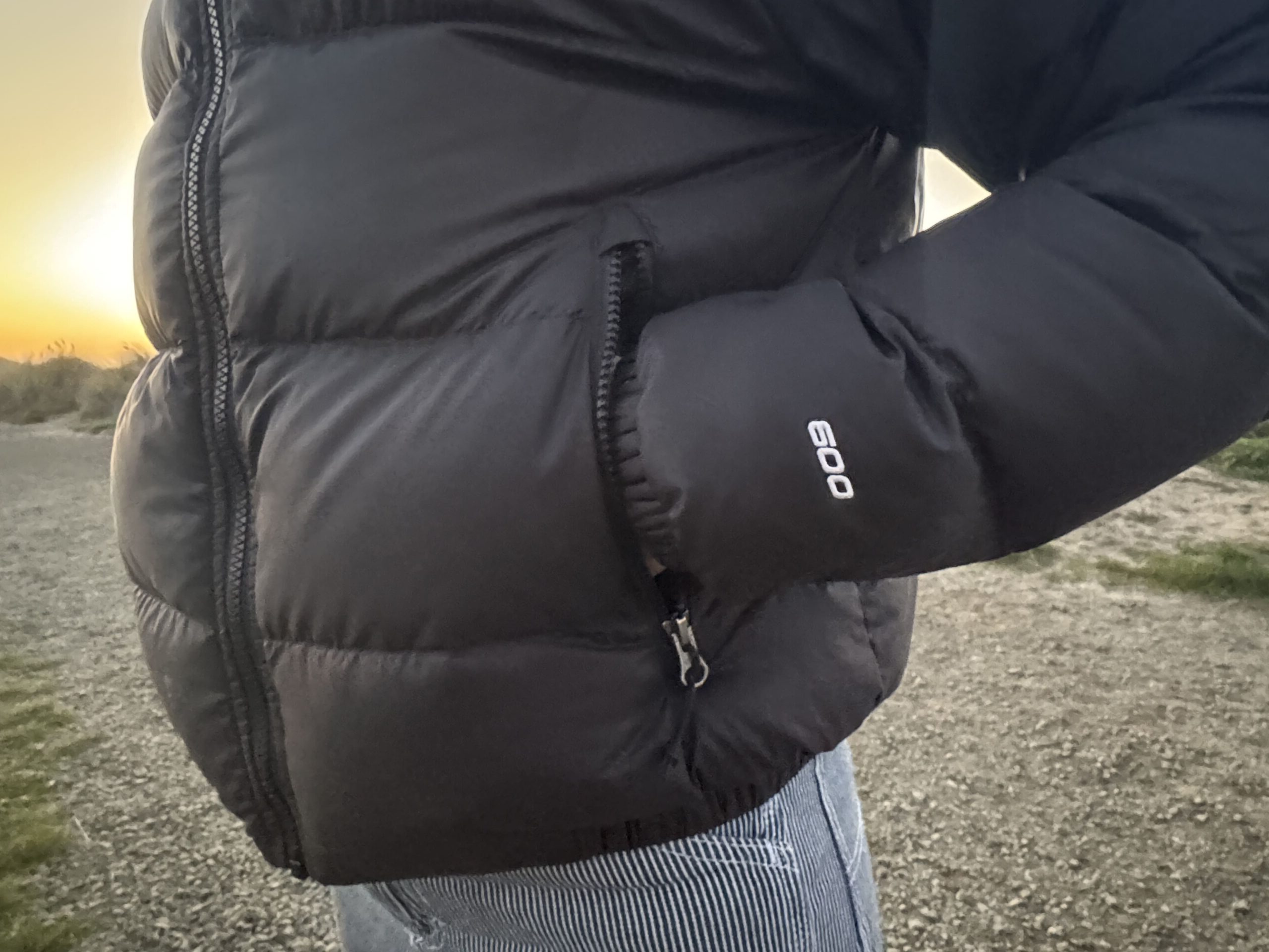 close up on the arm and waist on the north face hydrenalite down hoodie