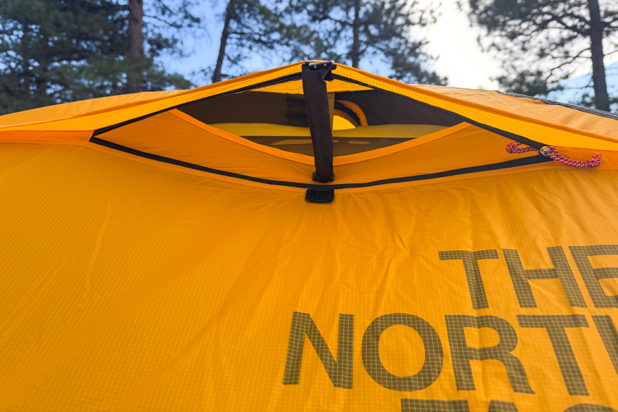 Close-up of the Mountain 25’s top fly vent, partially opened with a support strut, showing fabric tension and weatherproof vent design.