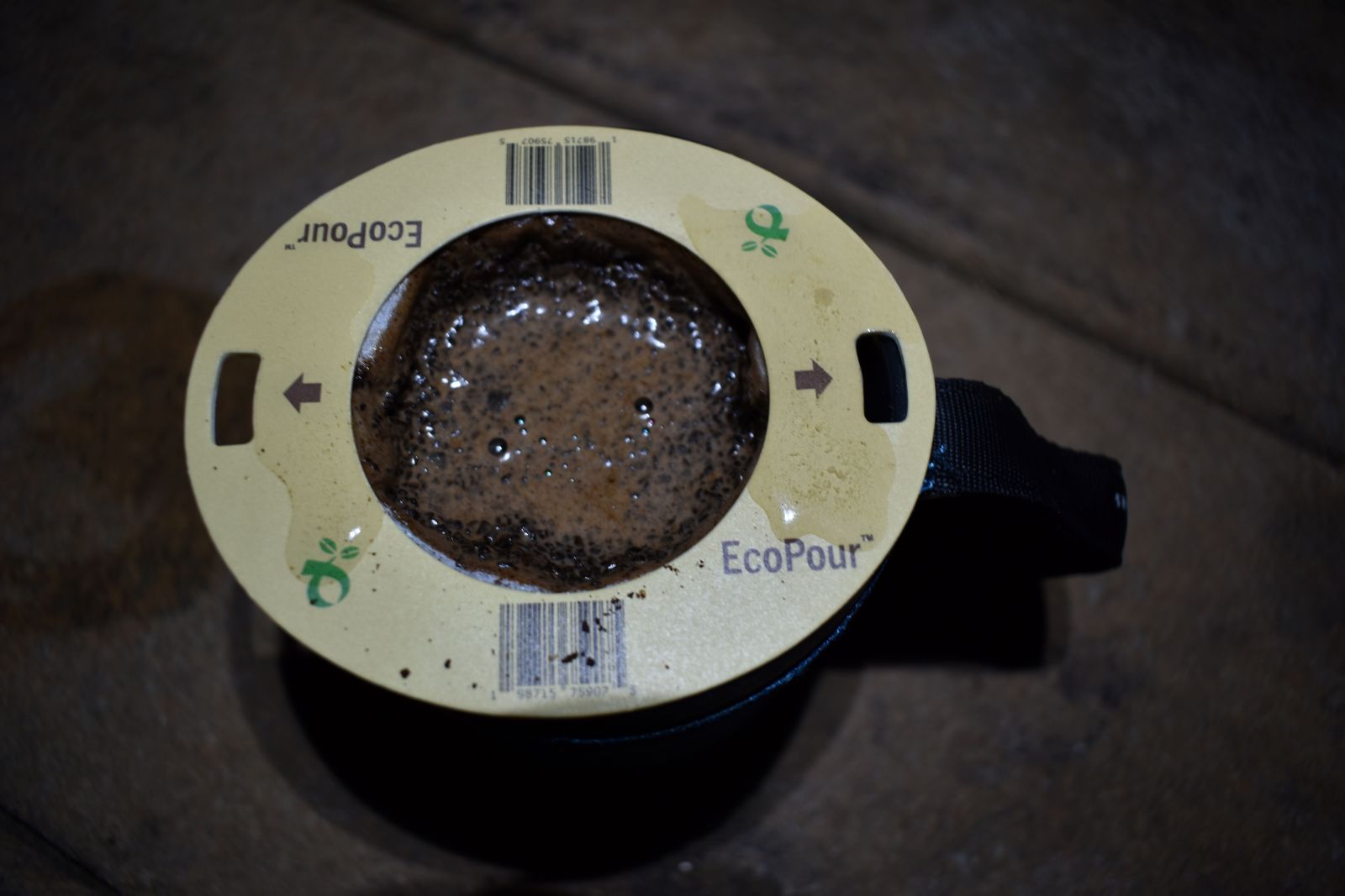 Air bubbles rise from soaked coffee grounds in a Coulee Coffee EcoPour filter pack