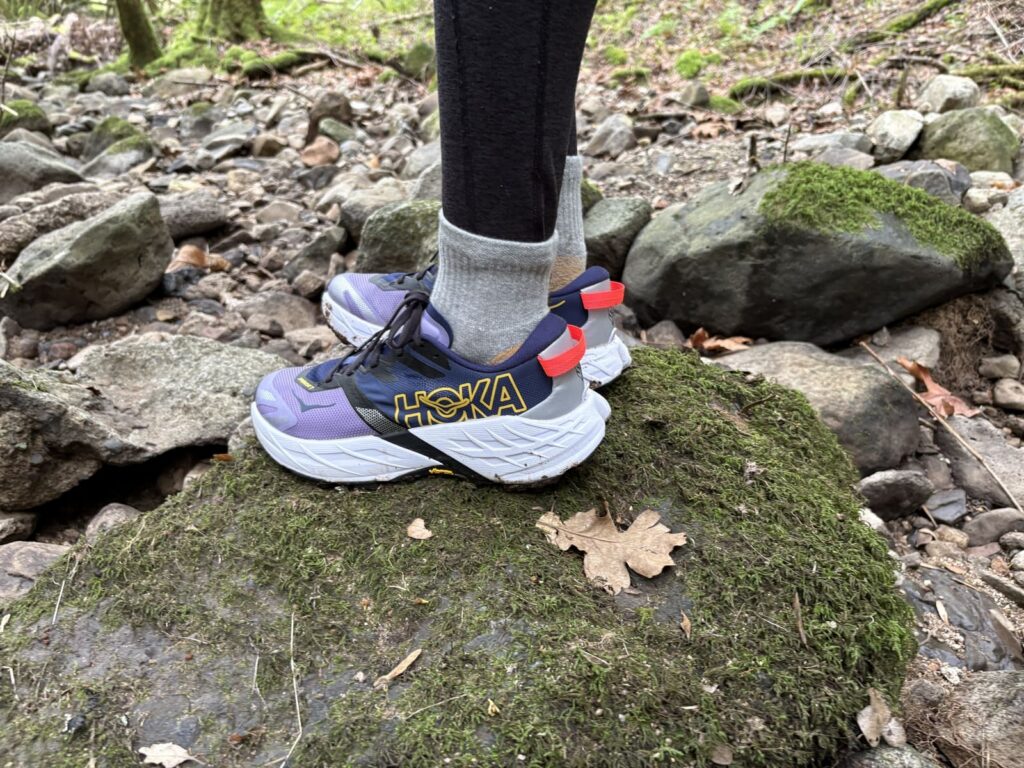 Side profile of a pair of Hoka shoes.