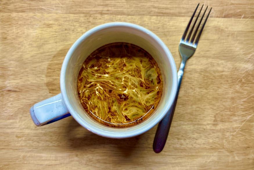 Up close image of a mug swirled with instant coffee.