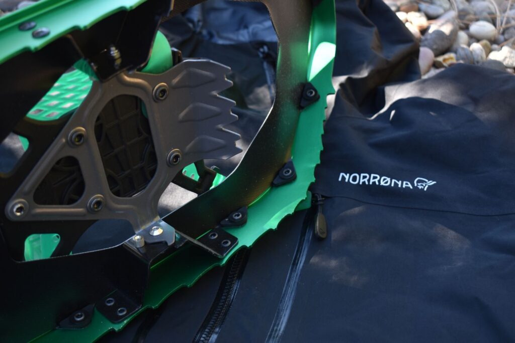 The serrated edge of a snow shoe against the abrasion-resistant face fabric of the Norrona trollveggen