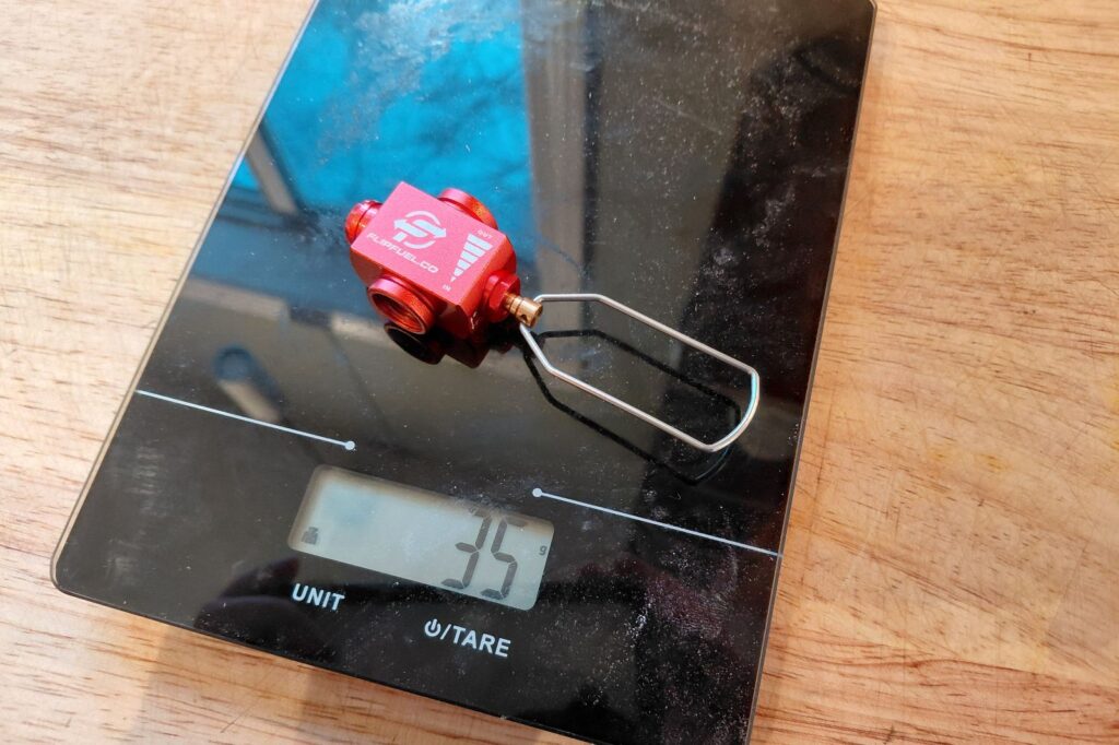 The FlipFuel device sits on a scale.