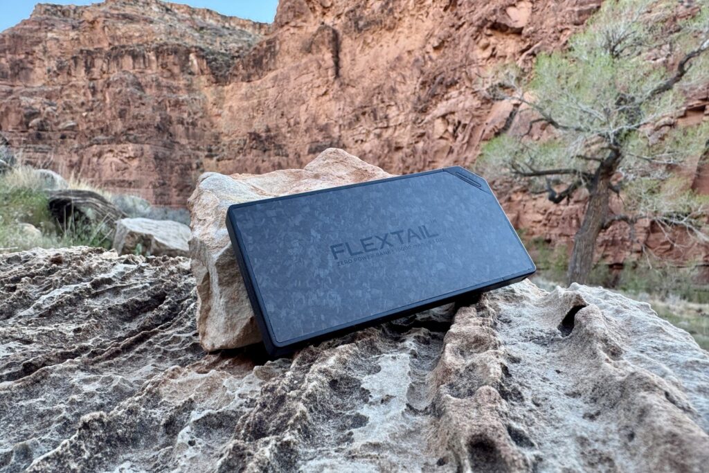 Close up of the Flextail sitting on a rock with a red rock canyon in the background.