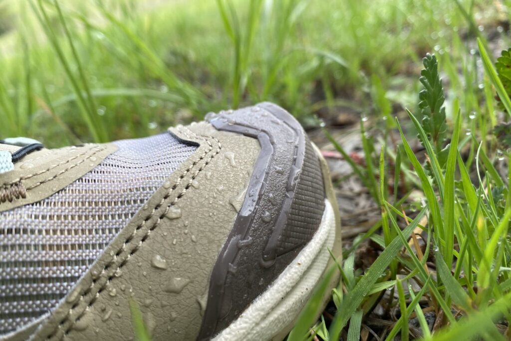 Closeup of water beading off a pair of shoes.