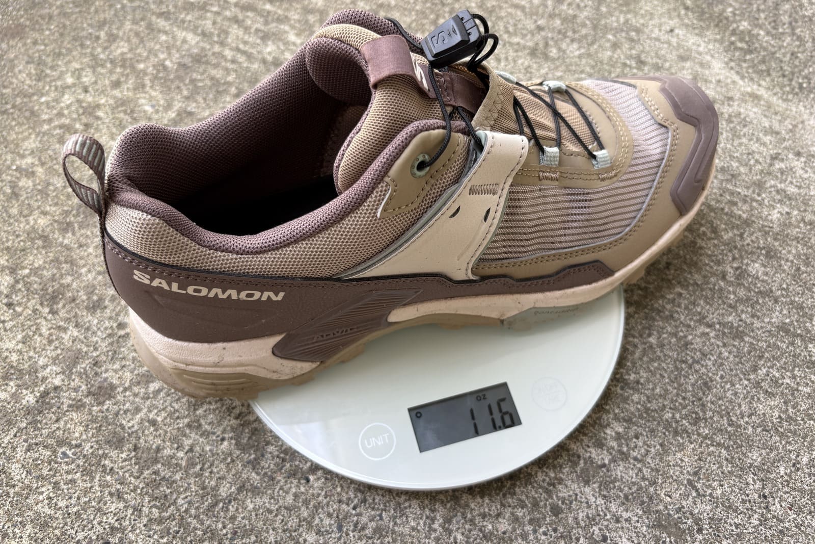 A shoe sits on a small kitchen scale.