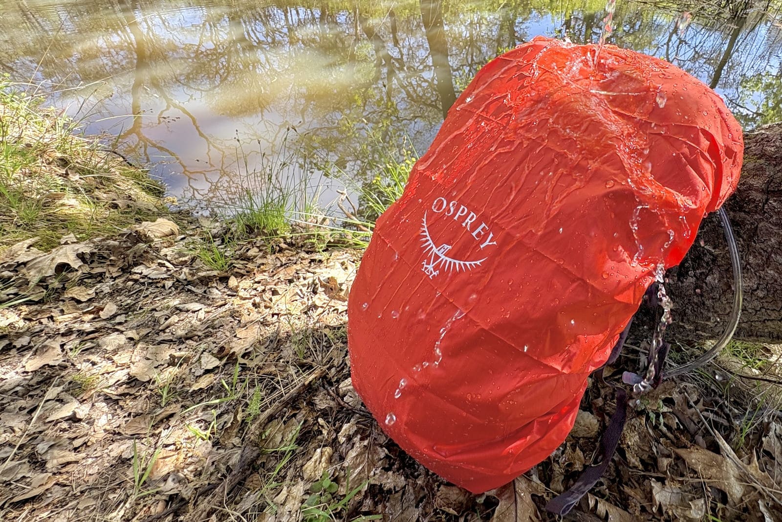 A backpack is covered with a rain cover to protect from water.