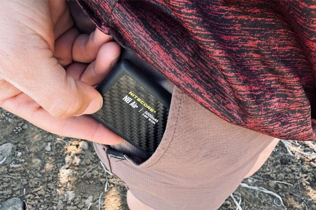 A closeup showing a hand pulling the NB Air out of a pants pocket.