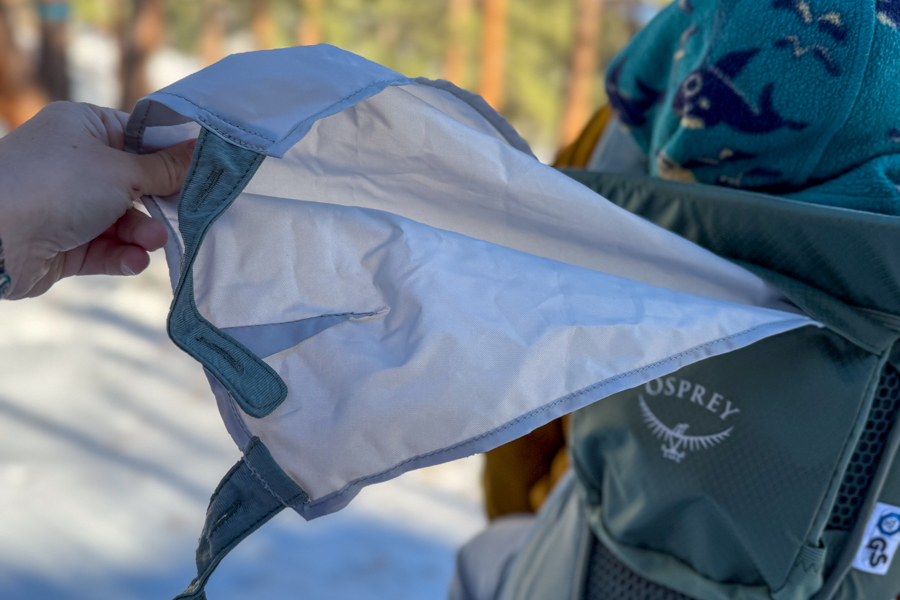 Close-up of the Osprey Poco Soft deployable sunshade being pulled out above the child seat.
