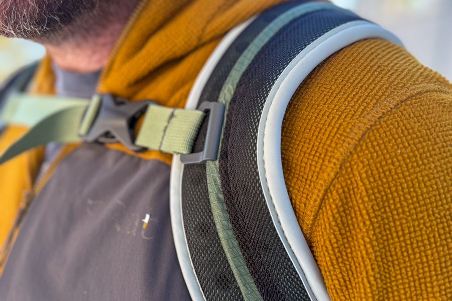 Close-up of the Osprey Poco Soft shoulder strap and sternum strap, showing the lightly padded mesh construction.