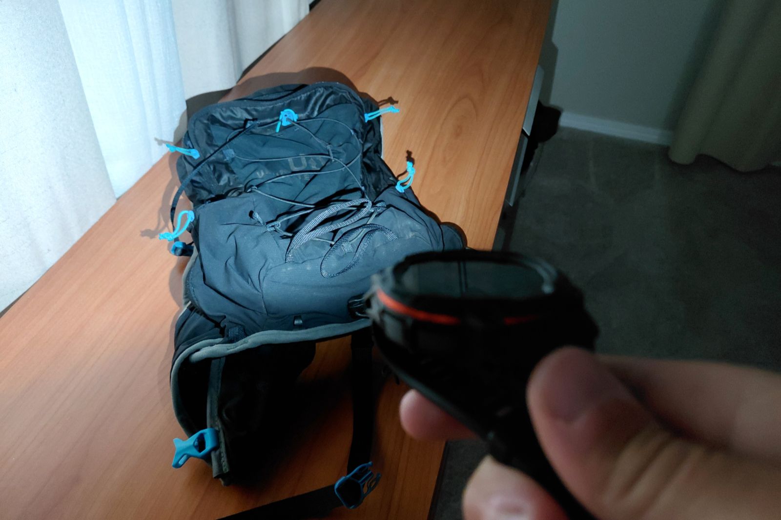 A watch with an LED flashlight illuminates a running vest.