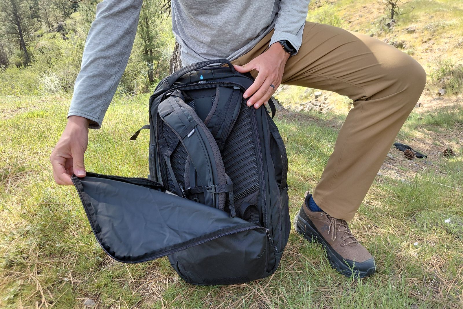 A man converts a travel backpack to a duffel.