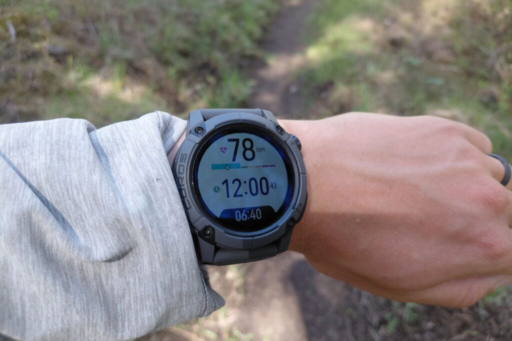 A close-up of a menu on a GPS watch worn on a wrist.