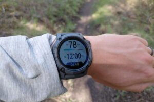 A close-up of a menu on a GPS watch worn on a wrist.