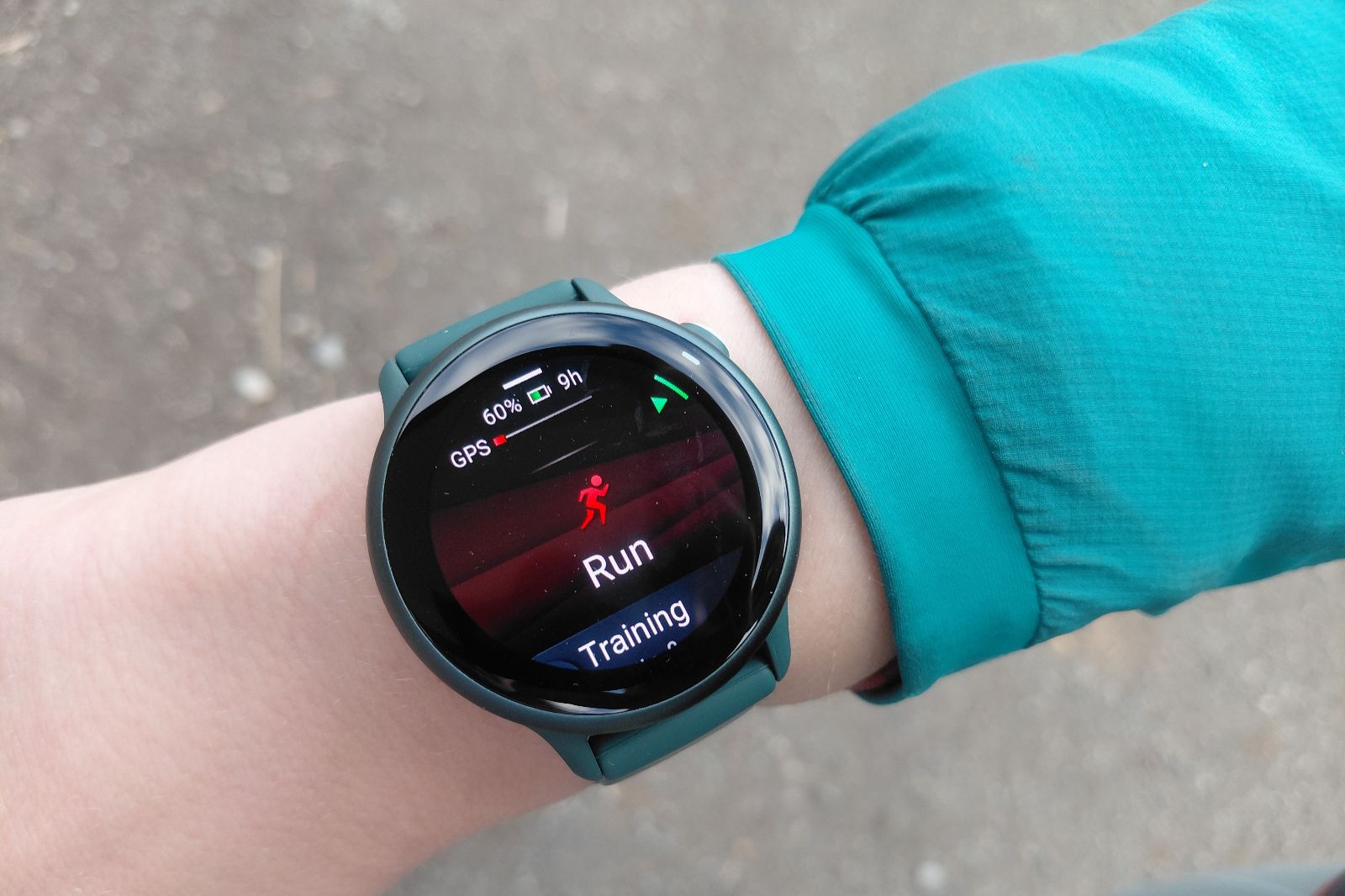 Smartwatch on a wrist, displaying a running app with a red icon and "Run" text.