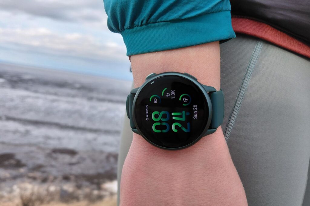 Close-up of a person wearing a smartwatch displaying fitness stats.