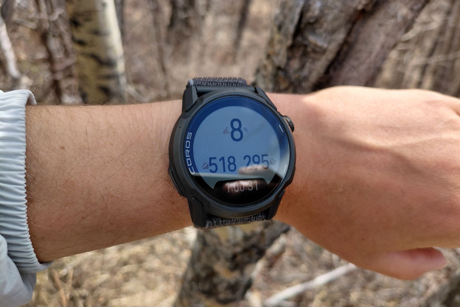 A black GPS showing hiking stats.