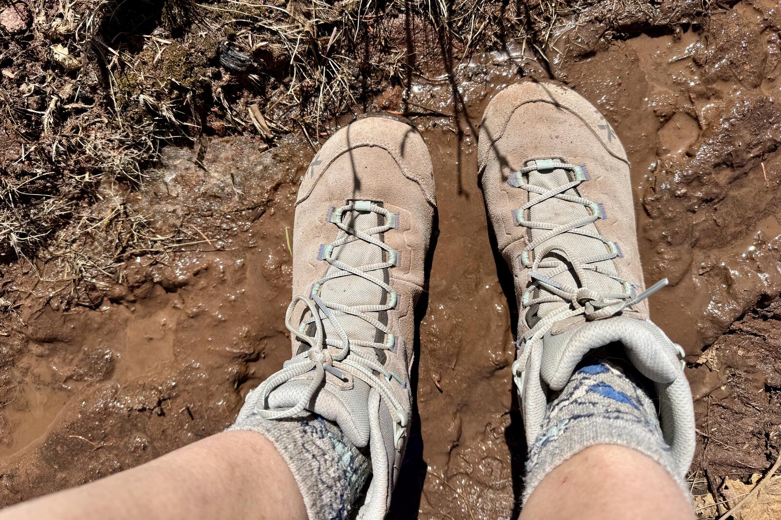 A close up of the TX Hike boots in some mud from the top looking down.