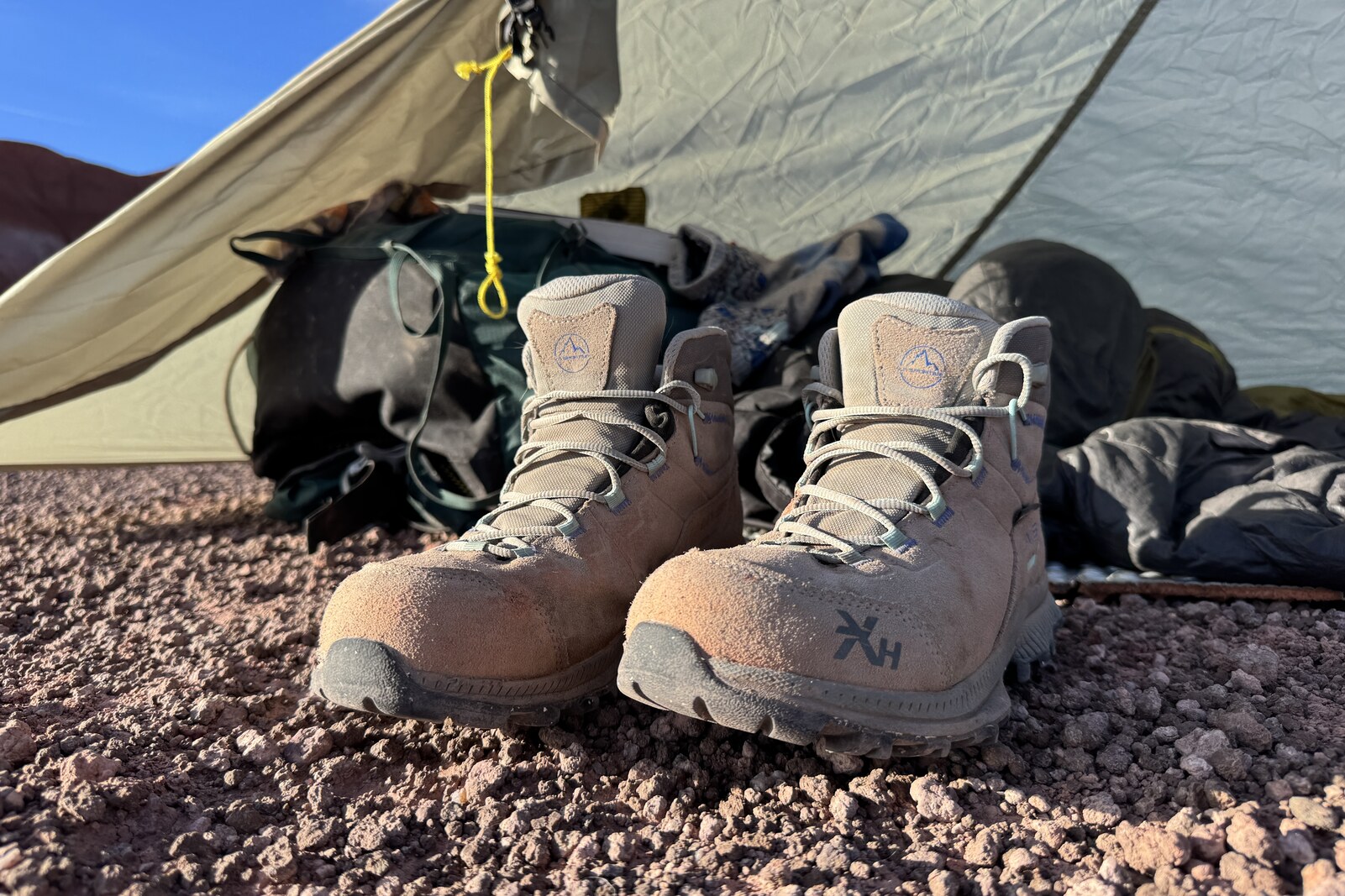 The TX Hike boots sitting in front of a backpack and tent.