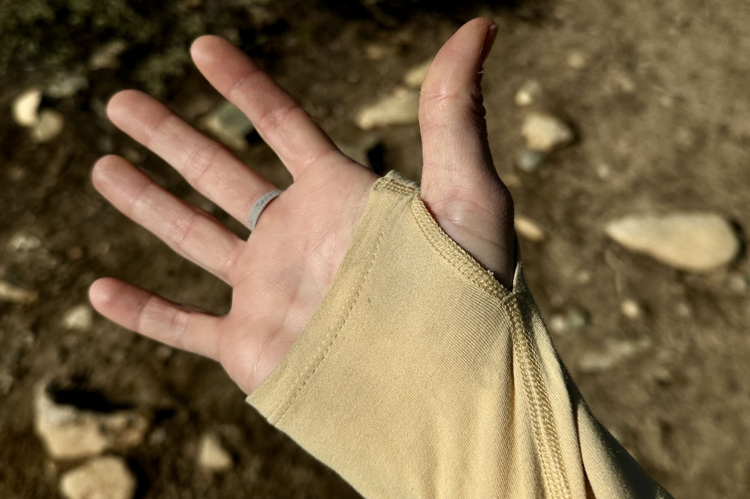 The palm of a woman's hand with a yellow sleeve covering most of the hand.