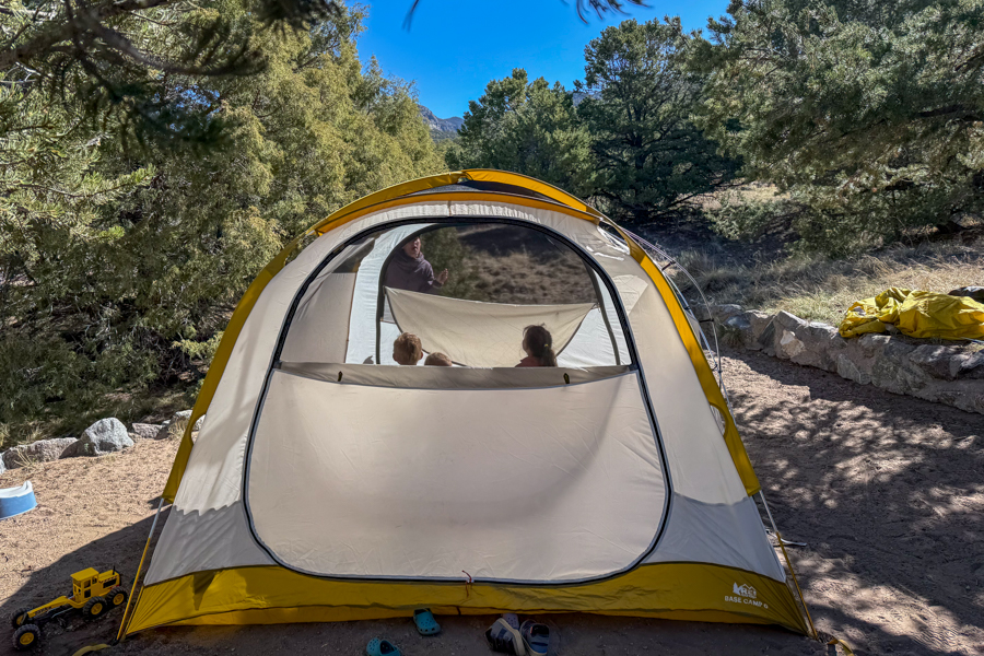 Front view of the REI Base Camp 6 tent body pitched at camp without the rainfly.