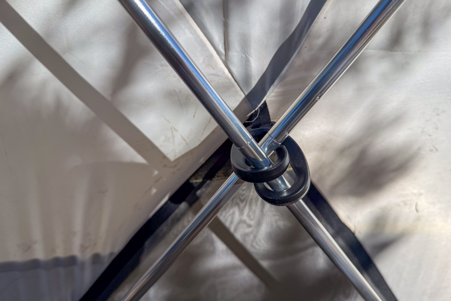 Close-up image of the Base Camp 6 tent's pole hub, where multiple aluminum poles intersect inside the tent.
