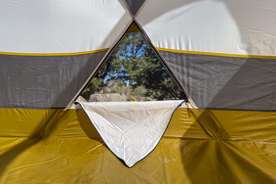 Interior view of the Base Camp 6 tent's triangular lower wall vent opened for airflow.