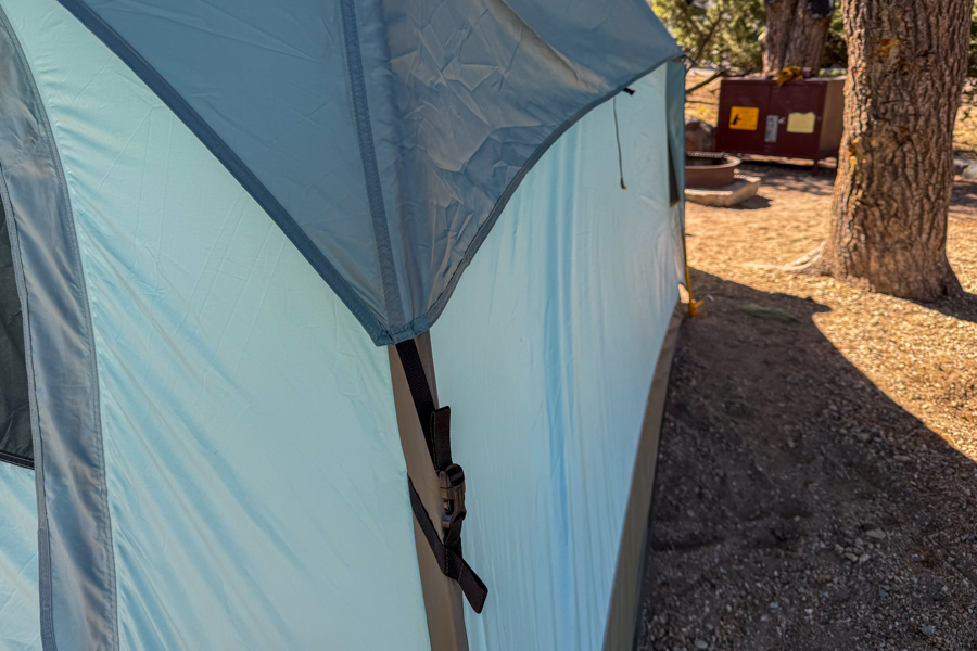 Close-up image of the REI Westward 6 tent's rainfly buckle attachment along the side of the tent.