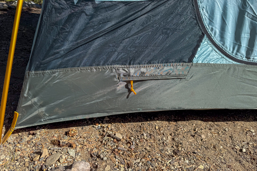Close-up image of the low exterior zipper on the outside of the REI Westward 6 tent that allows you to pass an extension cord through the tent body.