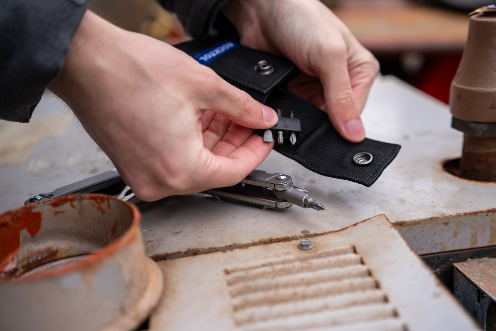 Hands hold swappable bits for use in a multi tool