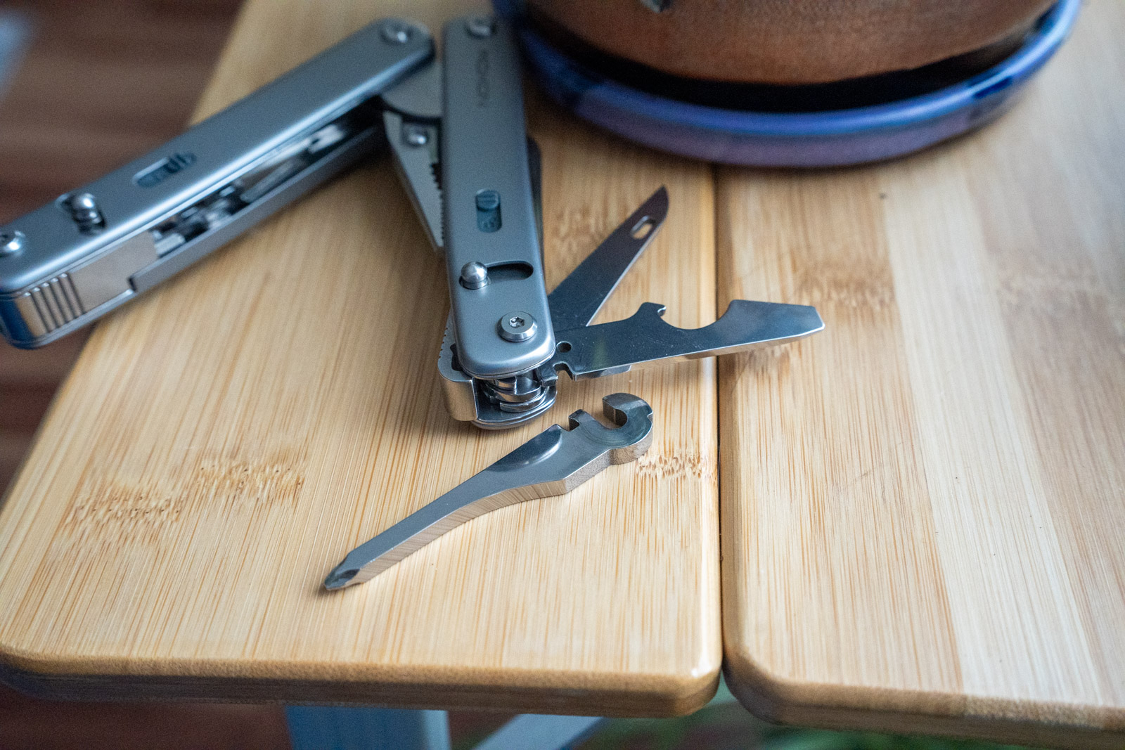 A modular multi tool with an implement sitting next to it on