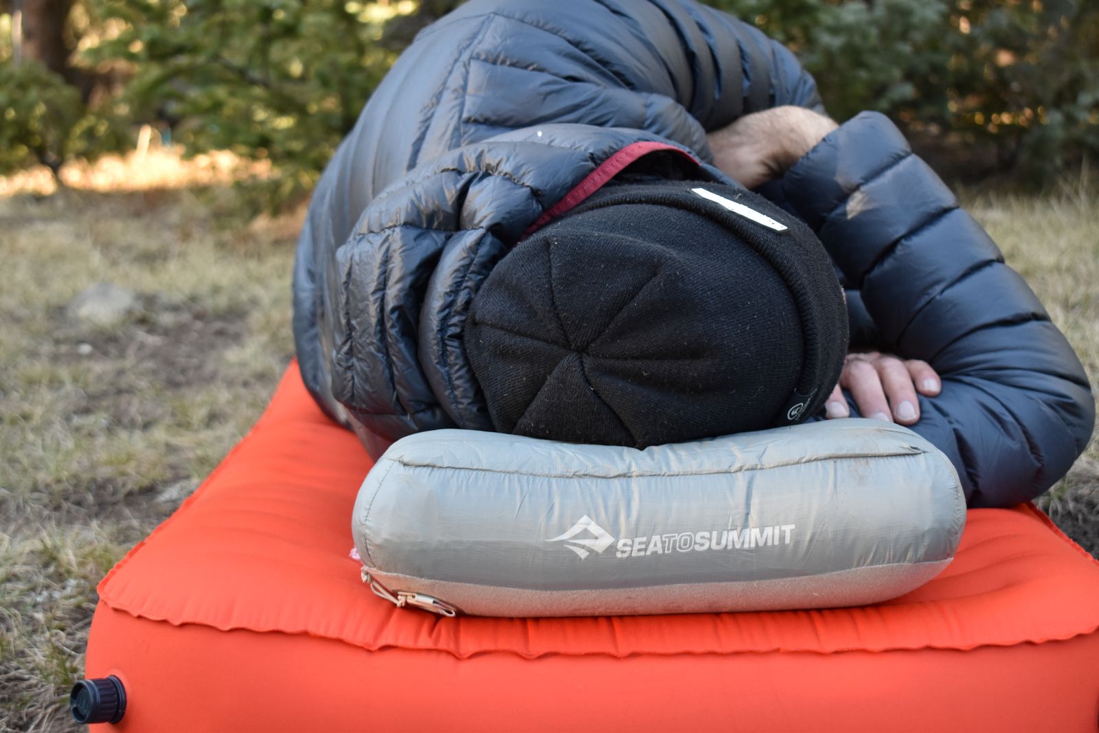 Our male tester sleeps on his side with the Aeros Down Pillow under his had and neck.