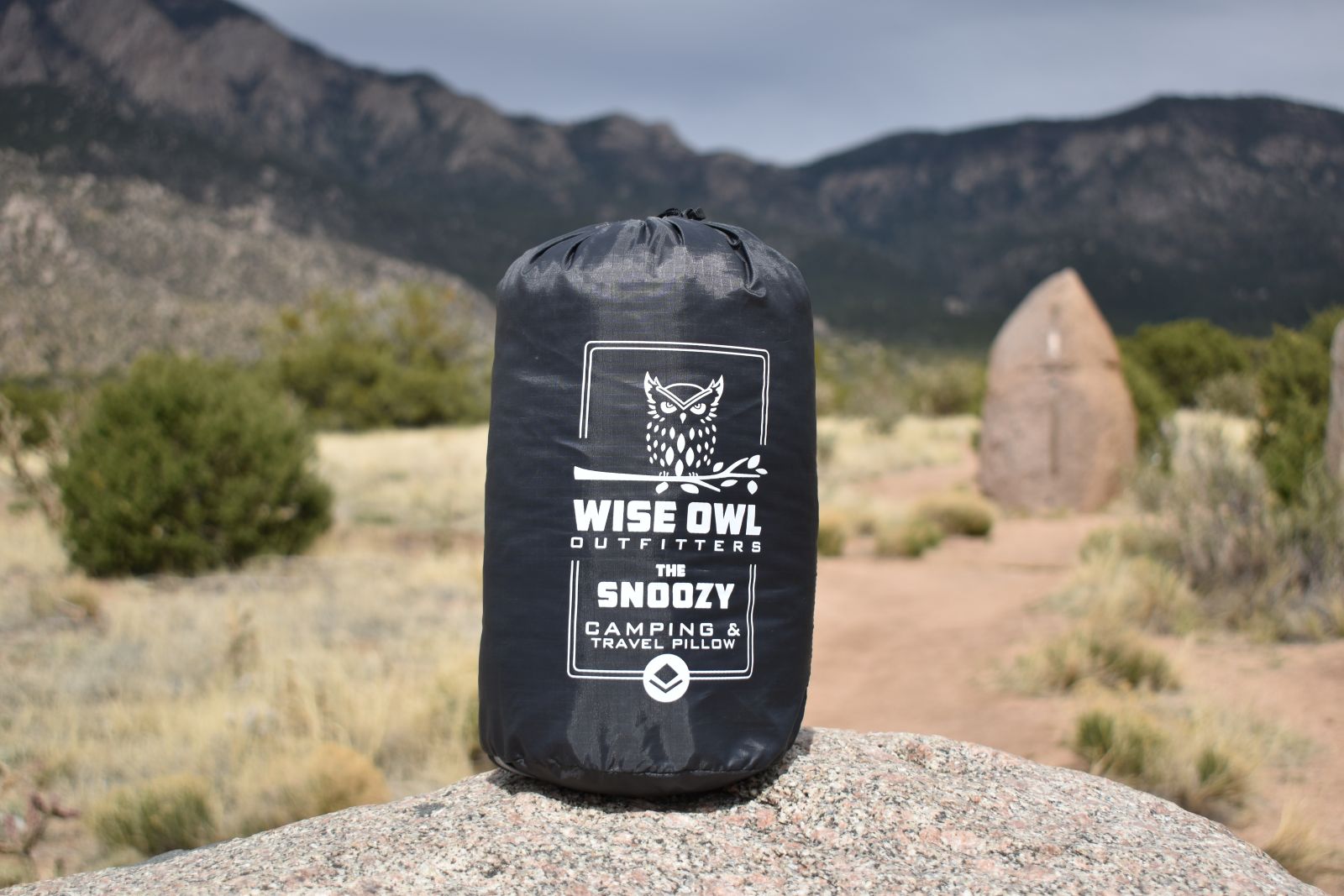 Wise Owl Snoozy pillow stuffed in its sack on a granite boulder in the Sandia Mountain foothills.