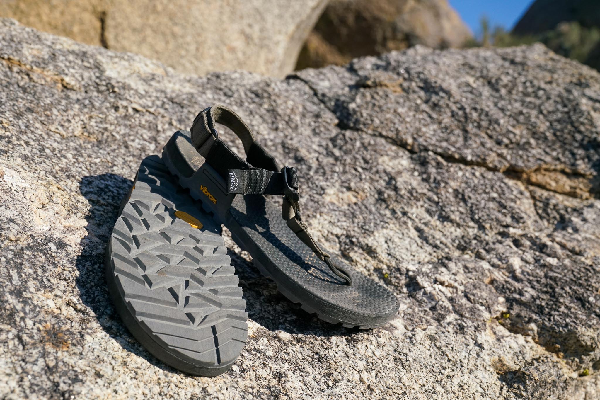 A close up of a pair of sandals sitting on top of a rock.