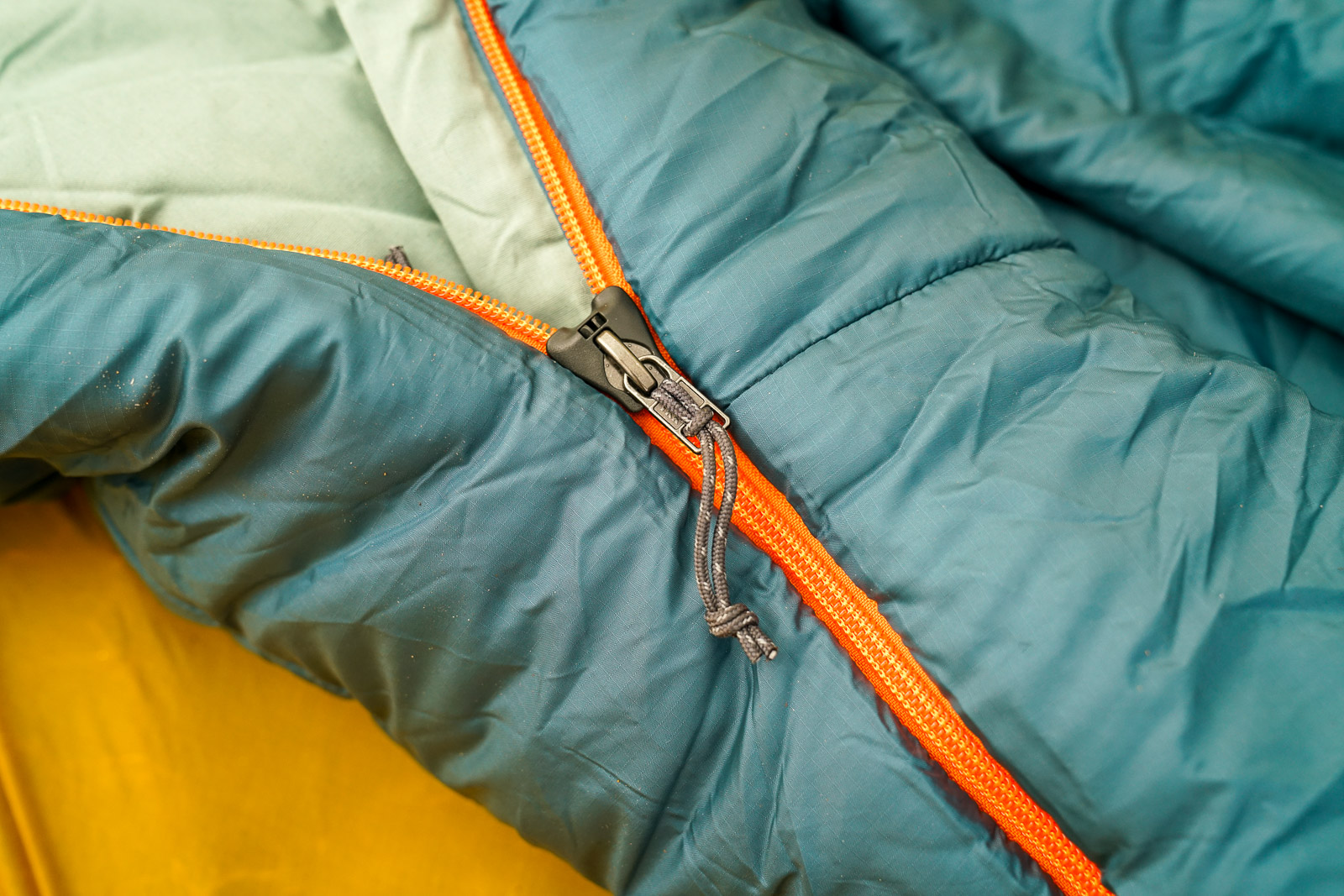 A close up of a sleeping bag zipper.